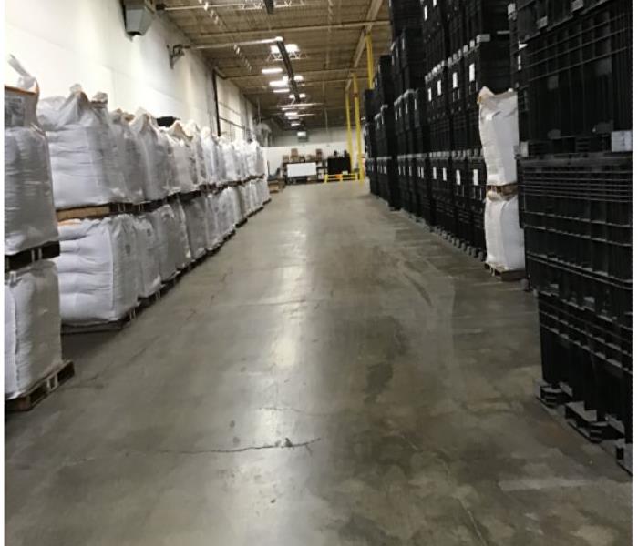 Warehouse with black boxes and white bags