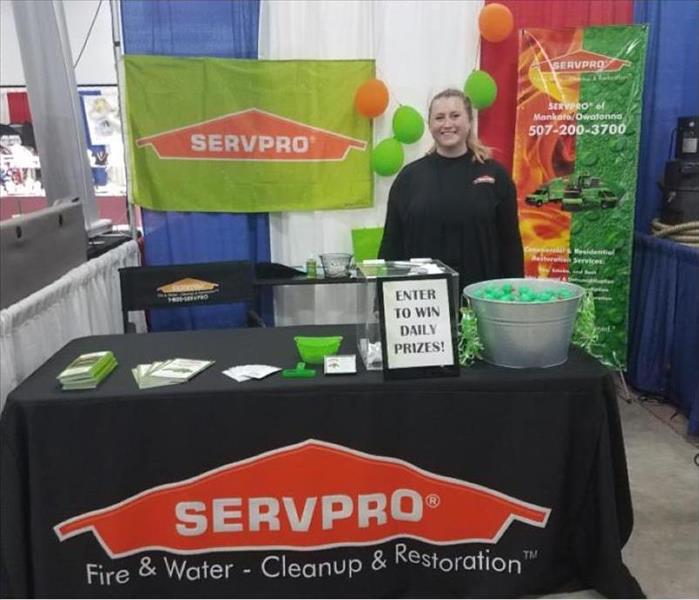 Black table with a duck pond game and SERVPRO giveaway items on it.